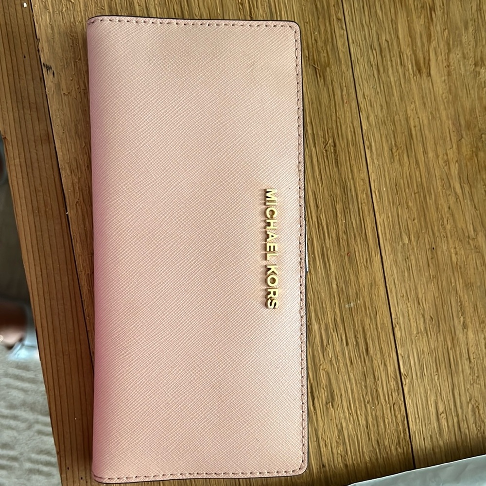 Michael Kors wallet. In great used condition. Lots of space and super cute.